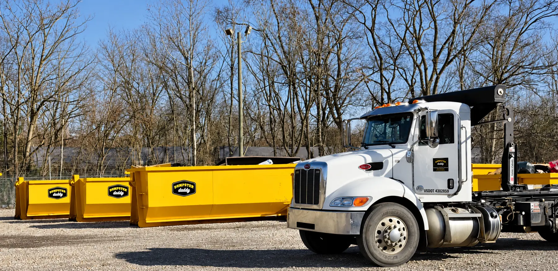 Dumpster Daddy roll-off truck and yellow dumpster serving Lake Martin, Alabama