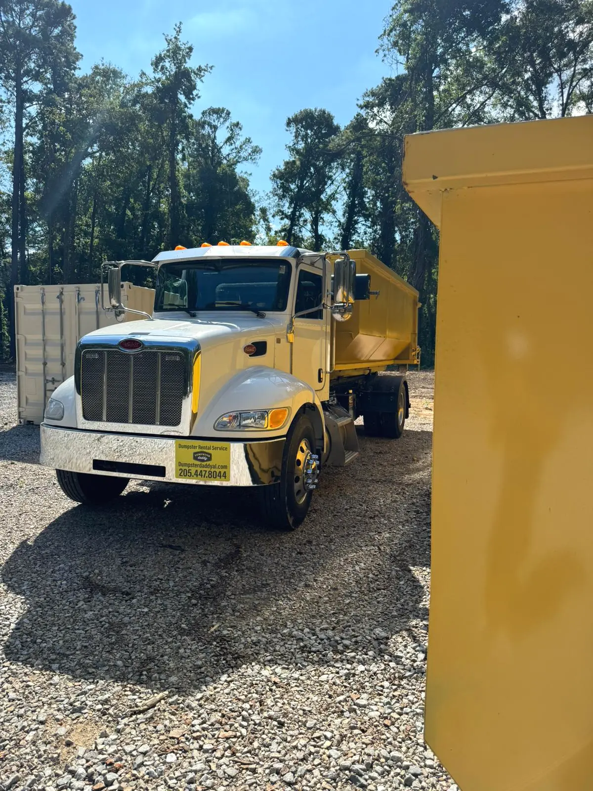 Dumpster Daddy roll-off truck and yellow dumpster serving Calera, Alabama